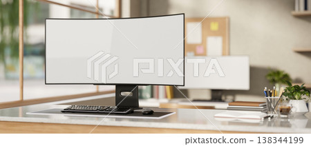 White curved screen computer with book and coffee on marble table across bulletin board in an office 138344199