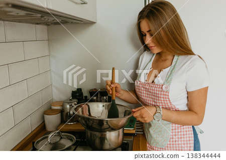 beautiful young chef decorating delicious dessert 138344444