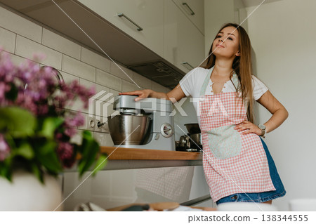 Young Woman Cooking in the kitchen. Healthy Food. Dieting Concept. Healthy Lifestyle. Cooking At Home. Prepare Food. Young Woman Cooking in the kitchen. Healthy Food. Dieting Concept. Healthy Lifestyle. Cooking At Home. Prepare Food. 138344555