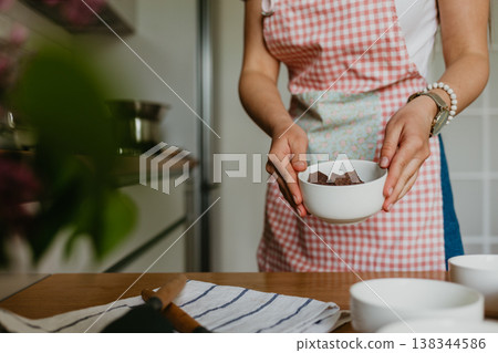 woman preparing a chocolate dessert. 138344586