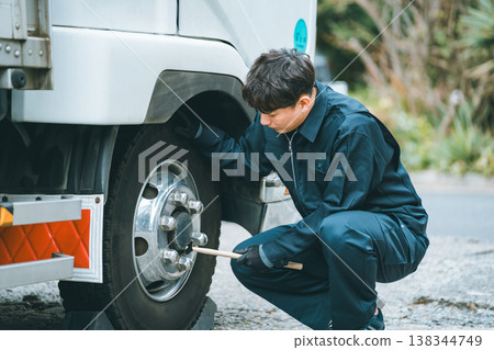Checking for loose nuts on trucks using an inspection hammer Checking for loose nuts on trucks using an inspection hammer 138344749