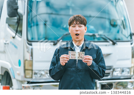 Truck driver with a wad of cash 138344816