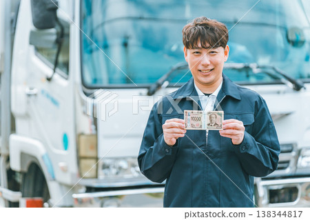 Truck driver with a wad of cash 138344817