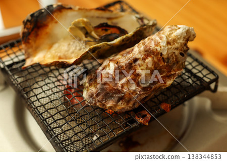 Grilled oysters over charcoal (seafood oyster grill photo) Grilled oysters over charcoal (seafood oyster grill photo) 138344853