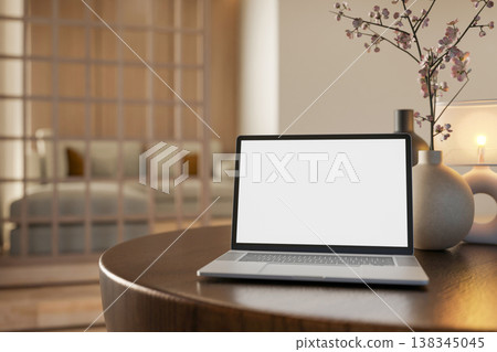 White screen laptop with lamp and vase on round wooden table across partition in modern living room White screen laptop with lamp and vase on round wooden table across partition in modern living room 138345045
