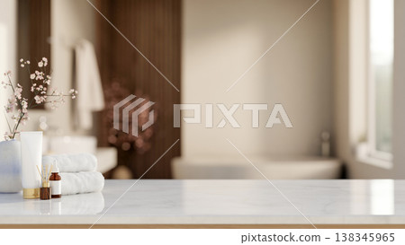 White towel with diffuser and skincare on shiny marble counter table across tub in a modern bathroom 138345965