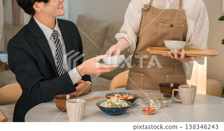 一對夫婦或一家人在餐桌上吃飯的場景(上菜、家常菜、家常飯菜、晚餐)。 一對夫婦或一家人在餐桌上吃飯的場景(上菜、家常菜、家常飯菜、晚餐)。 138346243