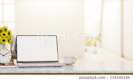 White screen laptop and coffee with clock and sunflower vase on marble counter table in bright room. White screen laptop and coffee with clock and sunflower vase on marble counter table in bright room. 138346246