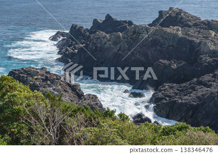 Wakayama Prefecture: Cape Shionomisaki (southernmost point of Honshu) / Close-up of Kurezaki (magma rock) jutting out from the cape [Nanki Kumano Geopark] Kushimoto Town 138346476