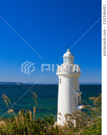 White lighthouse and blue sea 138346481