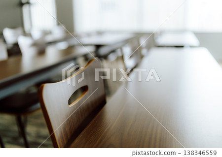 The wooden table and chairs in the foreground The wooden table and chairs in the foreground 138346559