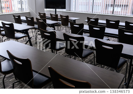 An empty conference room with desks and chairs 138346573