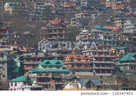 Dense Town View Shimla HillsLarge grouping of multi-story houses and hotels built across uneven terrain in Shimla, displaying urban growth in the Himalayas. Dense Town View Shimla HillsLarge grouping of multi-story houses and hotels built across uneven terrain in Shimla, displaying urban growth in the Himalayas. 138347403