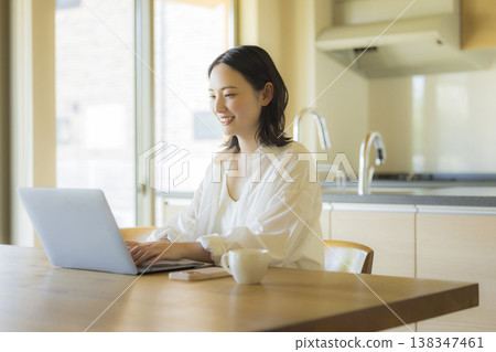 A woman using a computer 138347461