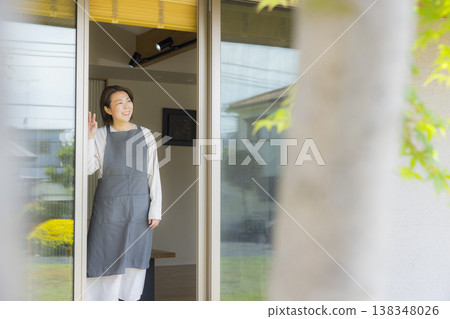 A woman looking out through the window A woman looking out through the window 138348026