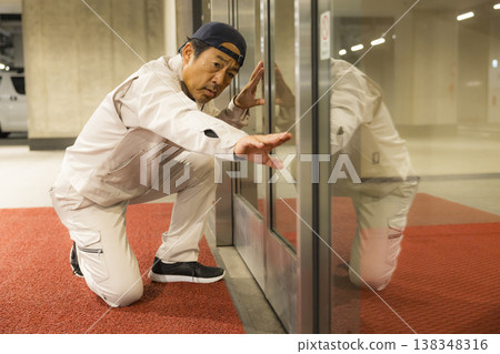 Workers inspecting automatic doors Workers inspecting automatic doors 138348316