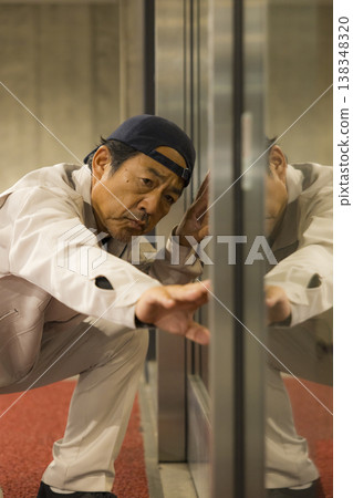 Workers inspecting automatic doors 138348320