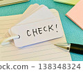 A vocabulary notebook with the word "check" written on it. 138348324
