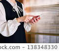 Woman operating a smartphone by the window 138348330