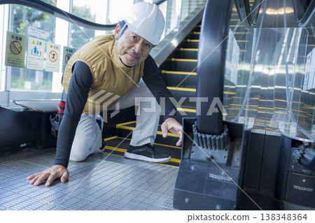 Workers inspecting escalators 138348364