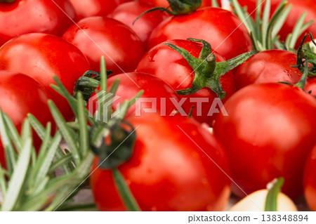 Close-up of fresh ripe cherry tomatoes with rosemary. Close-up of fresh ripe cherry tomatoes with rosemary. 138348894