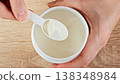 Close-up Measuring Protein Powder With Scoop From Container. Sports Nutrition And Fitness Supplement Dosage Concept. 138348984