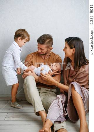 Parents And Child Smiling At Baby Together 138349011