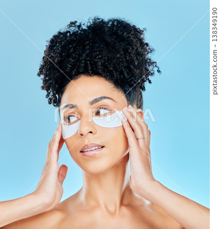 Woman thinking, face and under eye patch application for skin hydration glow, wellness or feel smooth skin results. Facial mask treatment, refresh and studio model plan anti aging on blue background 138349190