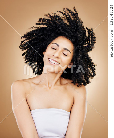 Hair, shake curls and wind, woman with beauty and treatment for shine, cosmetic care and smile on studio background. Wellness, haircare and growth with strong texture and curly locks, volume and afro Hair, shake curls and wind, woman with beauty and treatment for shine, cosmetic care and smile on studio background. Wellness, haircare and growth with strong texture and curly locks, volume and afro 138349224