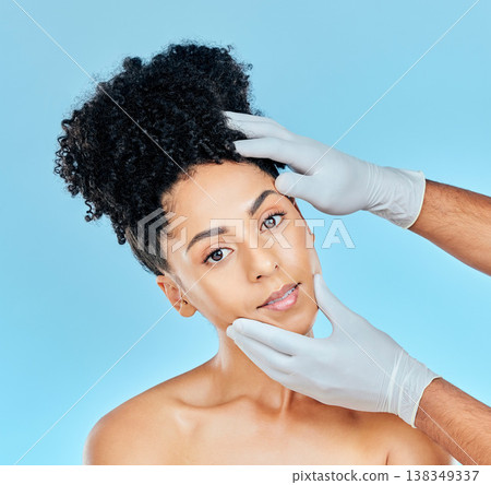 Facial, plastic surgery and portrait of woman with hands on face in studio for cosmetic beauty consultation. Skincare, dermatology and professional collagen therapy, face of model on blue background. Facial, plastic surgery and portrait of woman with hands on face in studio for cosmetic beauty consultation. Skincare, dermatology and professional collagen therapy, face of model on blue background. 138349337