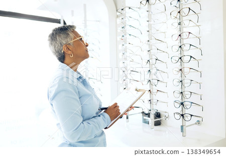 Doctor, eye care or mature woman with checklist in store for retail stock, inventory or eyewear choice. Vision, ophthalmology or optician in clinic writing on clipboard for glasses in optometry shop Doctor, eye care or mature woman with checklist in store for retail stock, inventory or eyewear choice. Vision, ophthalmology or optician in clinic writing on clipboard for glasses in optometry shop 138349654
