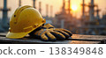 Yellow hard hat and safety gloves at industrial oil plant 138349848