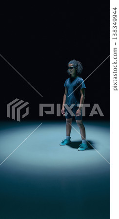 Female teenager athlete with augmented reality visor and data UI overlays in dark minimal studio. Female teenager athlete with augmented reality visor and data UI overlays in dark minimal studio. 138349944