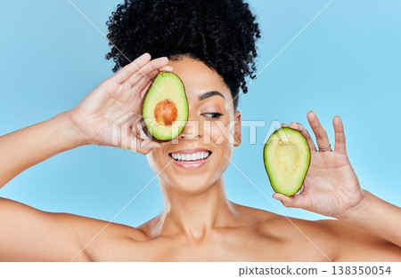 Skincare, avocado and happy woman in studio for cosmetic, wellness and treatment on blue background. Beauty, fruit and female model smile with organic, dermatology or detox for glowing skin routine Skincare, avocado and happy woman in studio for cosmetic, wellness and treatment on blue background. Beauty, fruit and female model smile with organic, dermatology or detox for glowing skin routine 138350054