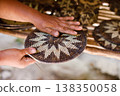 Hands Shaping a Traditional Mangyan Woven Basket Lid 138350058