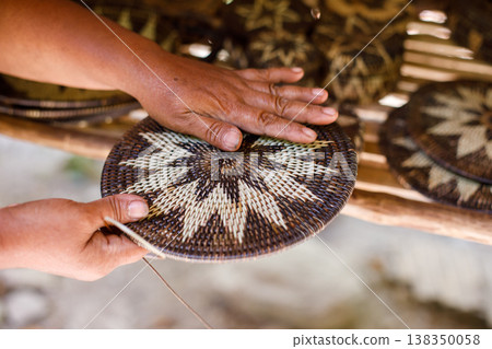 Hands Shaping a Traditional Mangyan Woven Basket Lid Hands Shaping a Traditional Mangyan Woven Basket Lid 138350058