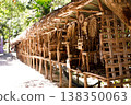 Village market stall displaying handmade bamboo crafts and woven baskets outdoors. 138350063