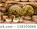 Village market stall displaying handmade bamboo crafts and woven baskets outdoors. 138350066