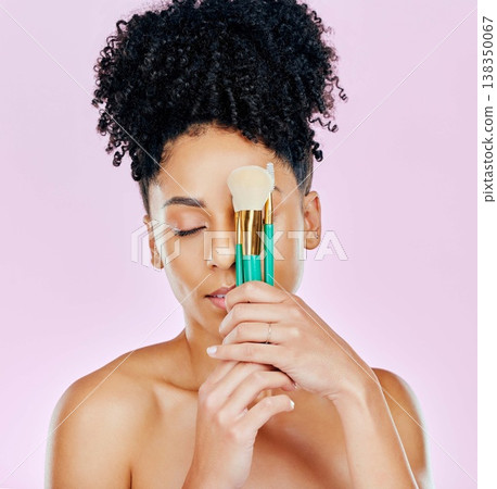 African, woman and brush for makeup on face fro beauty, cosmetic tools or pink background in studio. Cosmetics, artist and person with creative skincare brushes for foundation or powder application African, woman and brush for makeup on face fro beauty, cosmetic tools or pink background in studio. Cosmetics, artist and person with creative skincare brushes for foundation or powder application 138350067