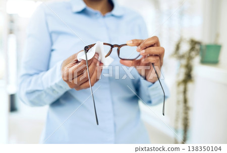 Hands, cleaning glasses with fabric and hygiene, vision and eye care with health and wellness. Person with eyewear, maintenance and wipe away dust with microfiber cloth, closeup and frame with lens Hands, cleaning glasses with fabric and hygiene, vision and eye care with health and wellness. Person with eyewear, maintenance and wipe away dust with microfiber cloth, closeup and frame with lens 138350104