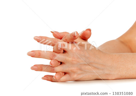 Beautiful female hands with french manicure isolated on a white background Beautiful female hands with french manicure isolated on a white background 138351080