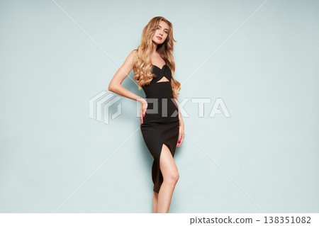 Young blonde woman in black evening dress 138351082