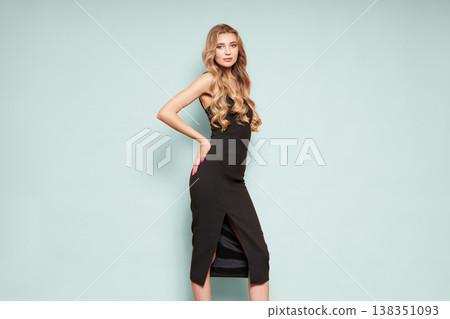 Young blonde woman in black evening dress Young blonde woman in black evening dress 138351093