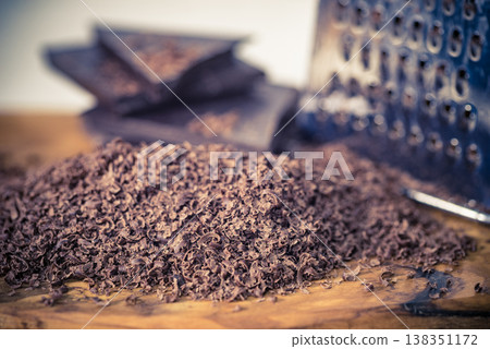 Grater and grated chocolate closeup Grater and grated chocolate closeup 138351172