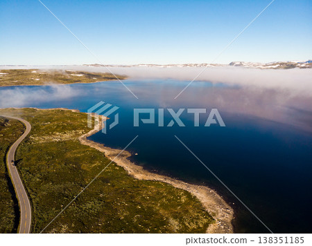 Road crossing Hardangervidda plateau, Norway. Aerial view. Road crossing Hardangervidda plateau, Norway. Aerial view. 138351185