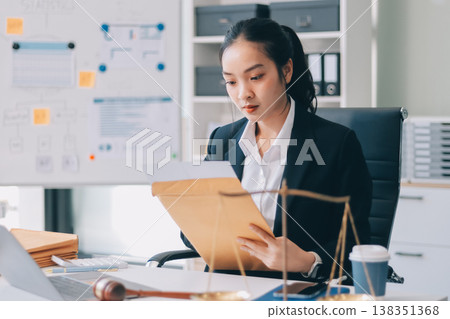 Lawyer explained to the client about the law that must be brought against the court case. Lawyer explained to the client about the law that must be brought against the court case. 138351368