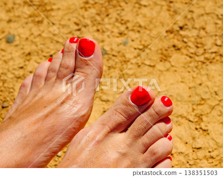 Female foot on beach 138351503