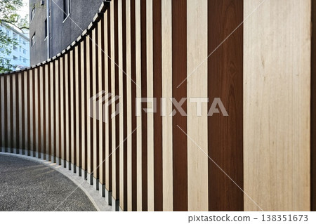 Wooden battens mounted on an underlying aluminum structure wall 138351673