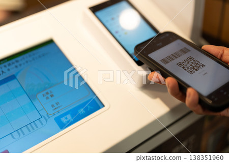 在收銀台，人們正使用智慧型手機進行非現金支付。 138351960