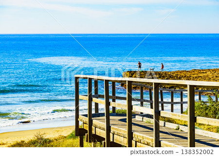 Beach with wooden path to sea water. Beach with wooden path to sea water. 138352002